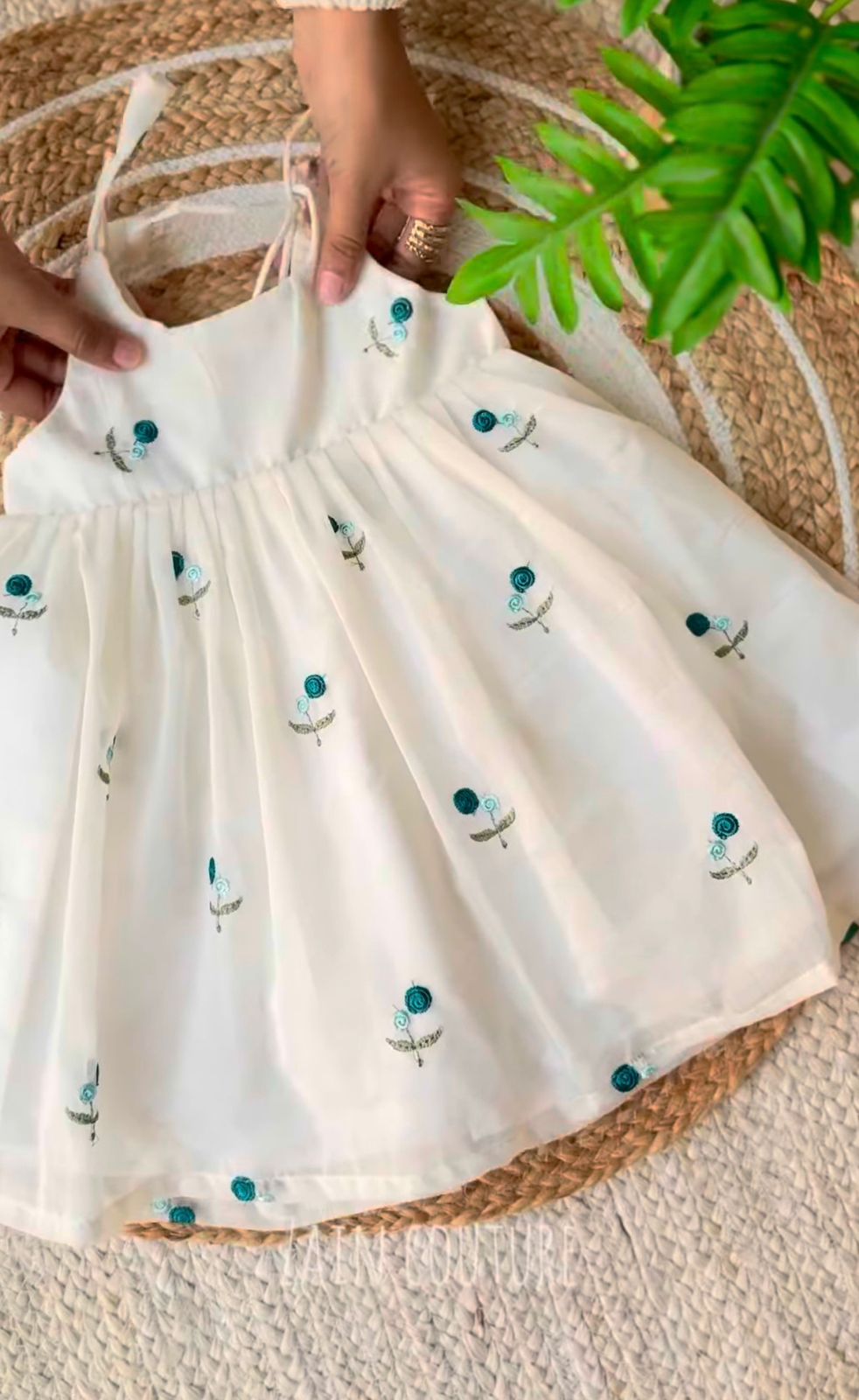 Enchanting Blossom: Ivory Strappy Frock with Teal Floral Embroidery