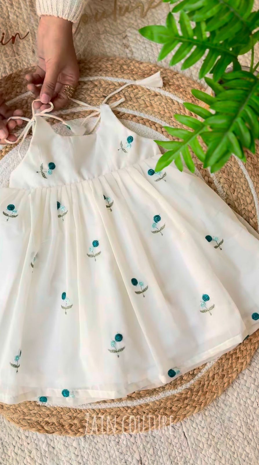 Enchanting Blossom: Ivory Strappy Frock with Teal Floral Embroidery